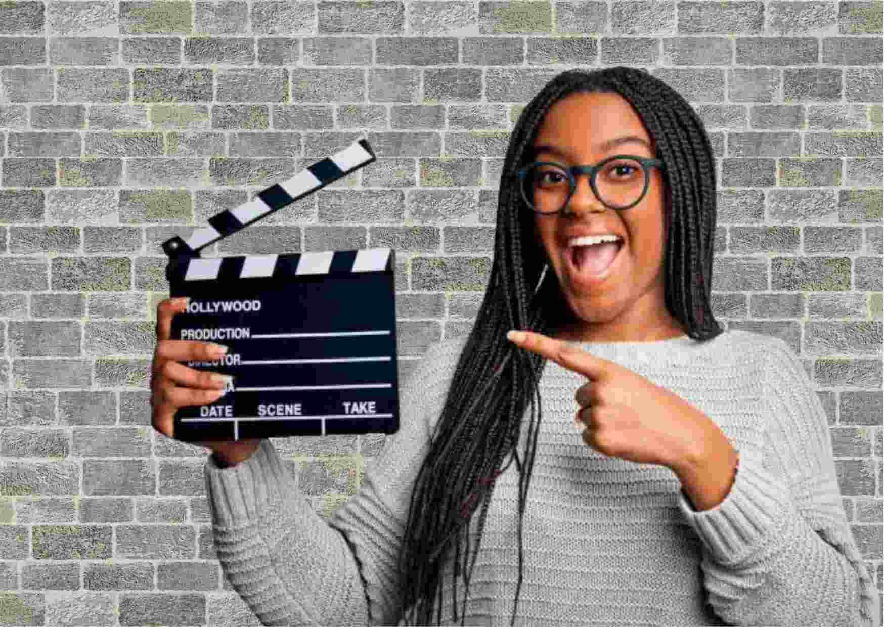 Female Movie Director holding a Clapperboard