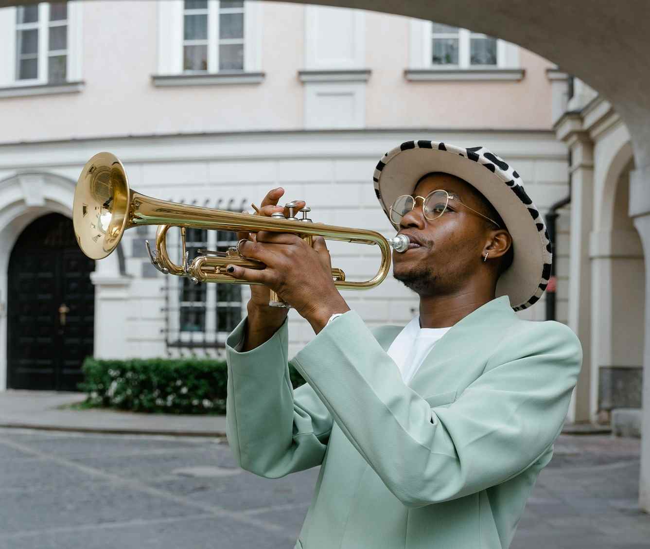 Wakacast Dot Com - Trumpeter standing in front of a building